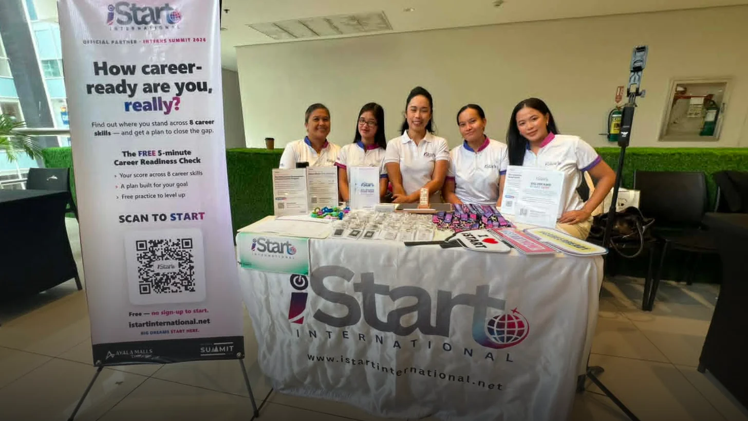The iStart booth fully set up and staffed before the summit doors opened — banners and standees up, brochures and giveaways laid out.